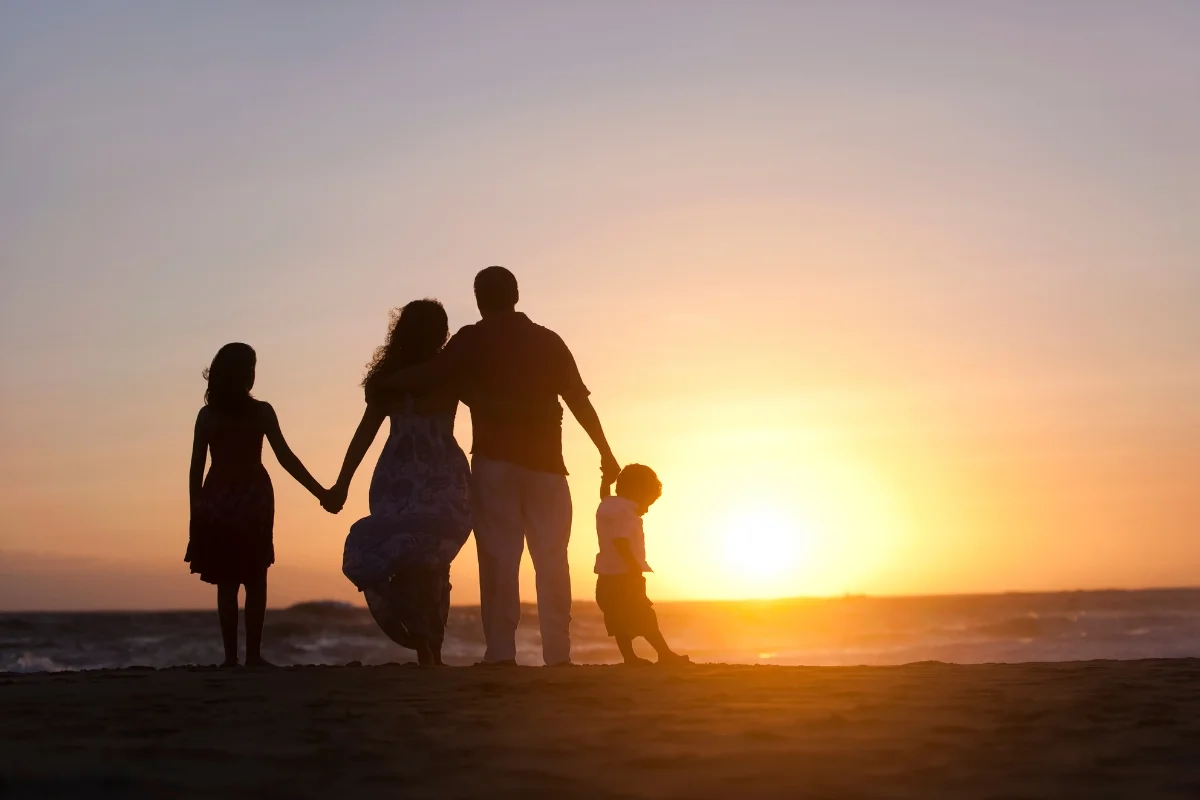 Family on a beach at sunset